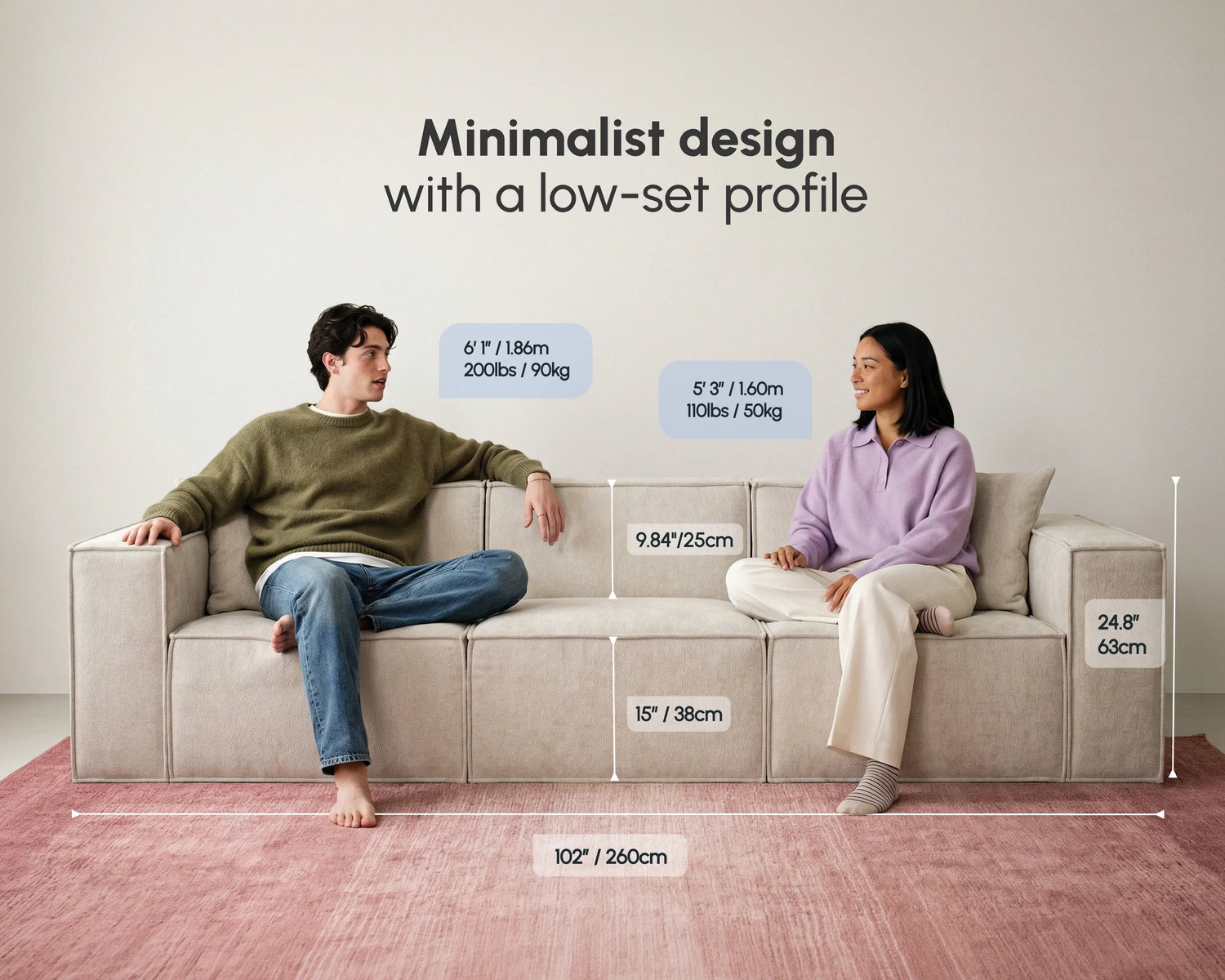 Two people sitting on a cream upholstered modular sofa, showcasing minimalist low-set design, soft fabric, spacious seating, and living room comfort.